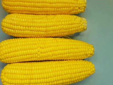 Photo of yellow corn kernels on a table, photographed from above. Stock Photos