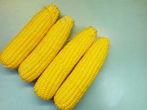 Photo of yellow corn kernels on a table, photographed from above. Stock Photos