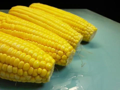 Photo of yellow corn kernels on a table, photographed from above. Stock Photos