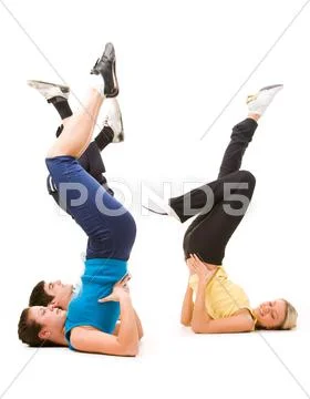 Photo of young adults doing physical exercise over white background Stock Photos