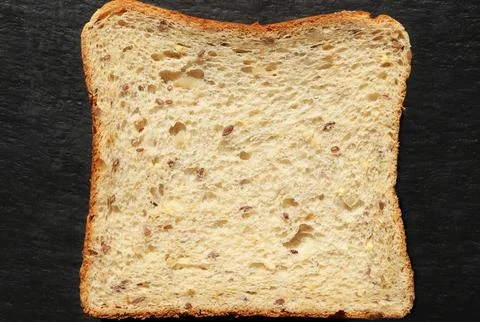 Photograph of a slice of bread on a slate background for food illustrations Foto stock