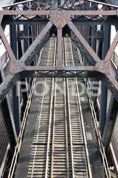 A photograph of train tracks on a bridge Stock Photos
