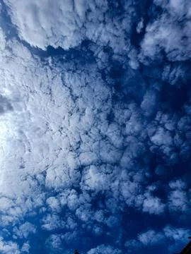 Photograph view of blue sky with beautiful white clouds and bright sun as a.. Stock Photos
