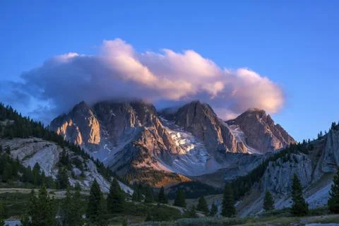 A  photograph of white clouds hovering over thenorthern part of a majestic .. Stock Photos