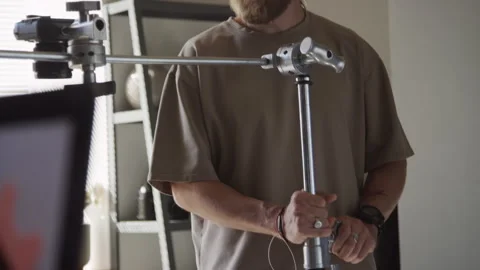 Photographer Adjusting Camera Rack Height to Shoot Flatlay in Studio Stock Footage 254376277