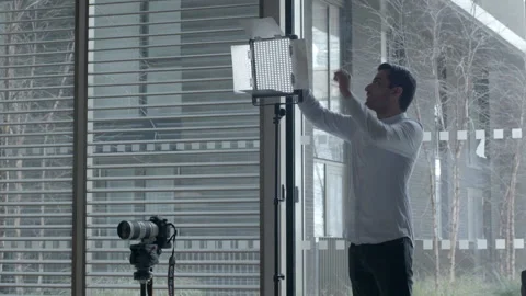 Photographer Adjusting Studio Lighting and Camera Stock-Footage 343968477