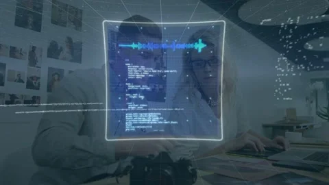 Photographer and editor leaning over DSLR and tablet, initiating holographic HUD Stock Footage 333602284