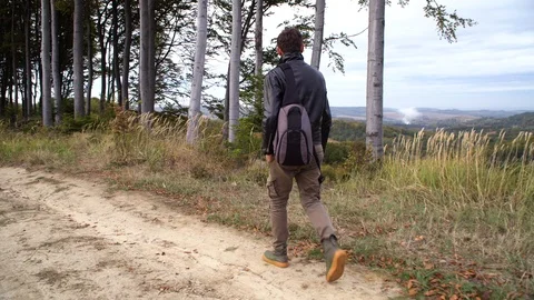 A photographer with a backpack full of equipment Stock Footage 119713067