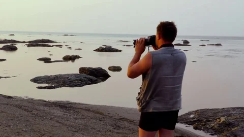 Photographer on the beach Stock Footage 77441511