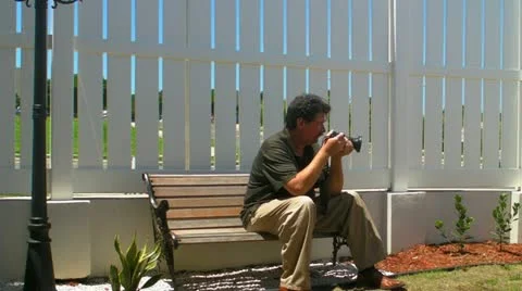 Photographer-bench-patio-park-2 Stock Footage 11131453