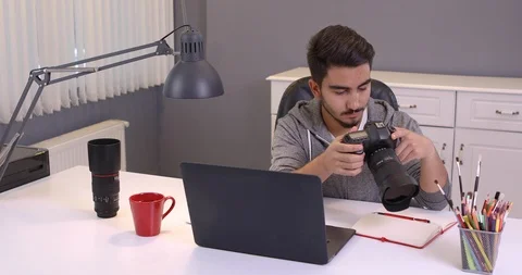 Photographer with camera and laptop computer Stock Footage 107767441