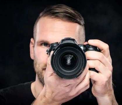 Photographer with camera on black. Stock Photos