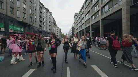 A photographer with a camera documents participants walking along the city Stock Footage 346239136