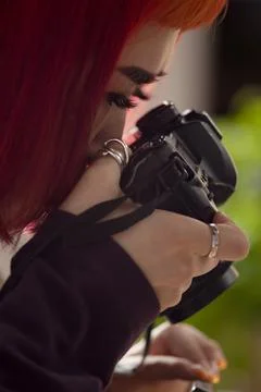 Photographer with a camera at work, close-up. Stock Photos