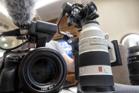 Photographer with a camera at work, close-up. Stock Photos
