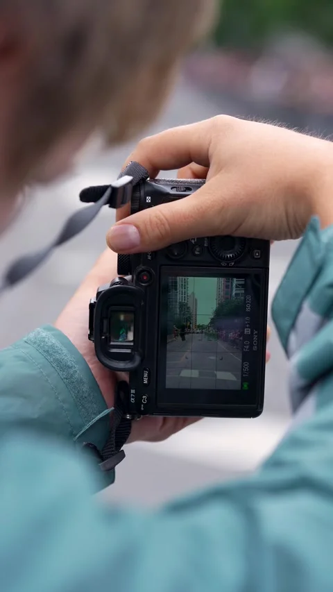 Photographer Capturing Pride Parade Moment on Camera Screen Video stock 332018034