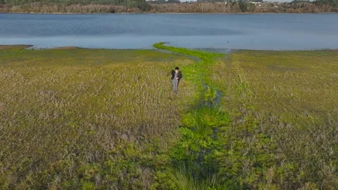 Photographer Carrying Camera On Tripod While Walking Stock Footage 264637579