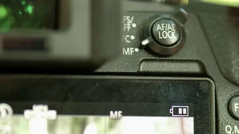 Photographer changes camera autofocus setting Stock Footage 116960499