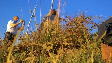 The photographer changes the camera when shooting a model in the park among the 스톡 동영상 101994649