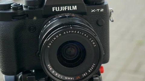 Photographer changing aperture on lens Stock Footage 117167953