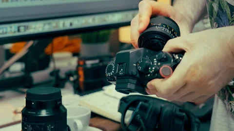 Photographer changing camera lens Stock Footage 336099299
