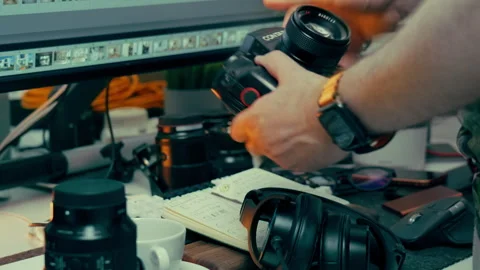 Photographer changing camera lens Stock Footage 336099397