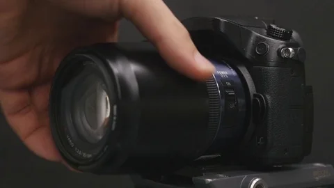 Photographer changing lens on camera Stock Footage 85029012