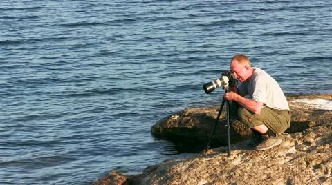 Photographer on the coast Stock Footage 21224568