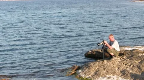 Photographer on the coast Stock Footage 21228282