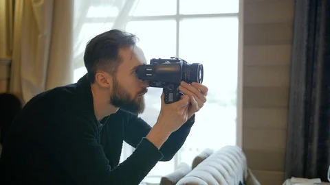Photographer composing and framing image, focusing and shooting with medium Video stock 73987918