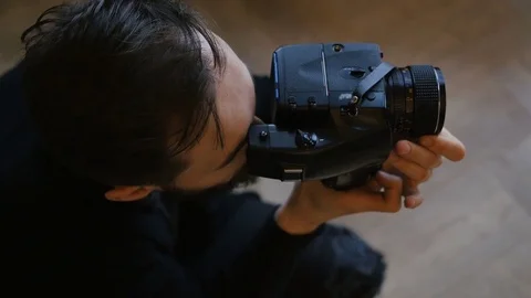 Photographer composing and framing image, focusing and shooting with medium Stock Footage 73991008