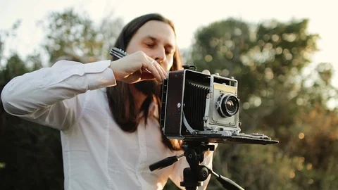Photographer customizes large format camera before shooting Stock Footage 106311839