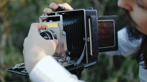 Photographer customizes large format camera before shooting Stock Footage 106312033