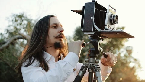 Photographer customizes large format camera before shooting Stock Footage 106313420