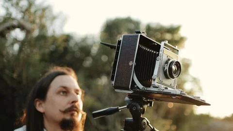 Photographer customizes large format camera before shooting Stock Footage 106315430