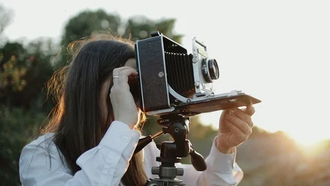 Photographer customizes large format camera before shooting Stock Footage 106316166