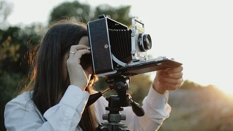 Photographer customizes large format camera before shooting Stock Footage 106316740