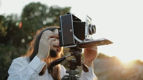 Photographer customizes large format camera before shooting Stock Footage 106317156
