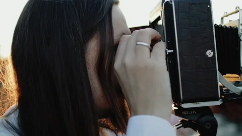 Photographer customizes large format camera before shooting Stock Footage 106317331