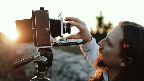 Photographer customizes large format camera before shooting Stock Footage 106319453