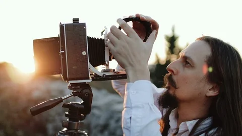 Photographer customizes large format camera before shooting Stock Footage 106319609