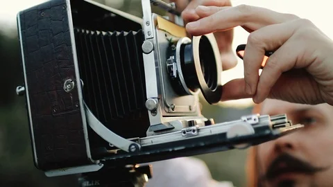 Photographer customizes large format camera before shooting Stock Footage 106320039