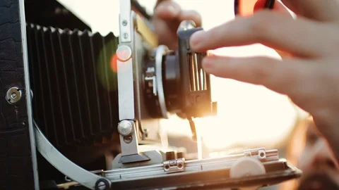 Photographer customizes large format camera before shooting Stock Footage 106320297