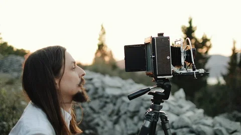 Photographer customizes large format camera before shooting Stock Footage 106320536