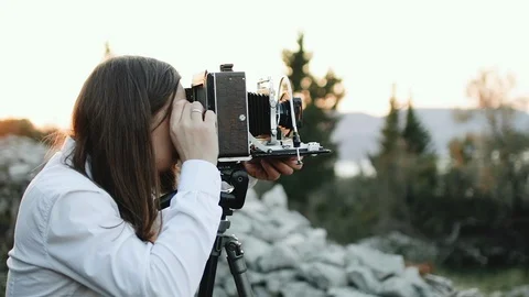 Photographer customizes large format camera before shooting Stock Footage 106320979