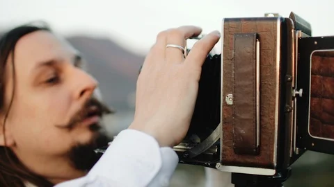Photographer customizes large format camera before shooting Stock Footage 106321418