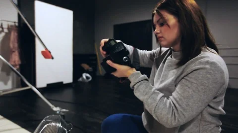 Photographer doing her work in art process in photo studio Stock Footage 85478104