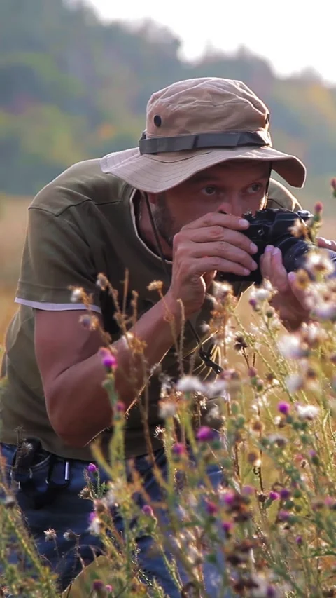 Photographer doing his work in the evening sunshine. Vertical video. Stock Footage 305023896