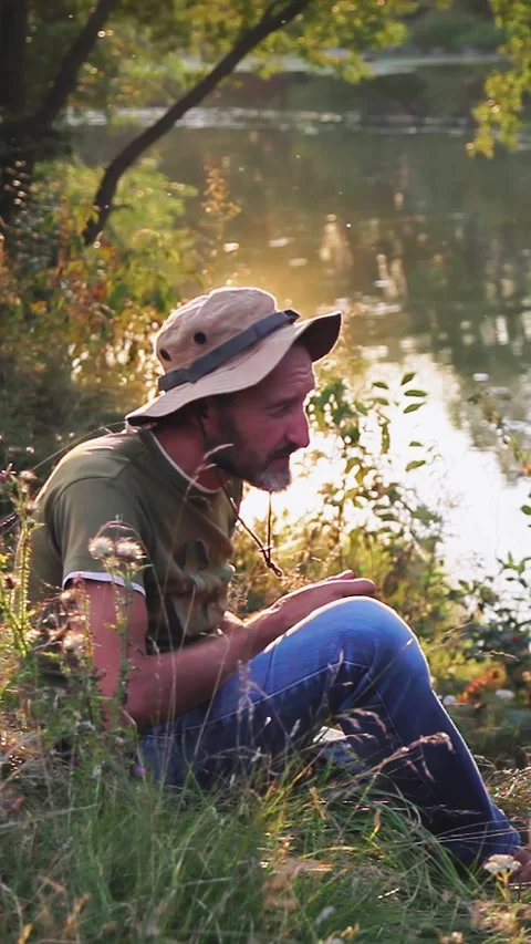 Photographer doing his work in the evening sunshine. Vertical video. Stock Footage 305024046