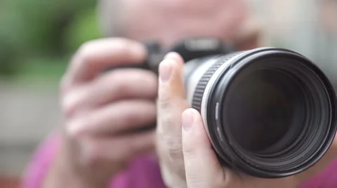Photographer frames the camera with a big lens of the camera Stock Footage 67811840